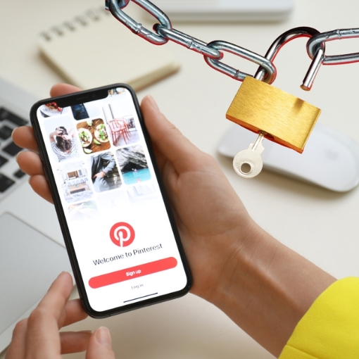 woman holding a phone, welcome to Pinterest is on the phone screen. image of a lock and key in top right corner