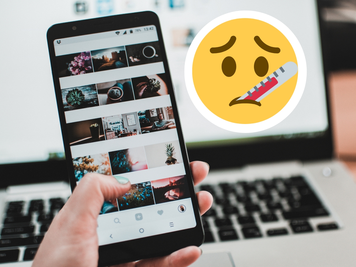 Hand holding a mobile phone with a instagram feed on it, is your business instagram glitch proof. sad emoji face with thermometer in mouth